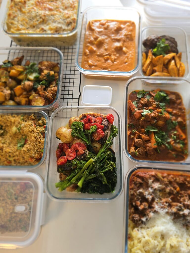 A full week of chef-prepared meal prep in containers, curries, traybakes, pasta bake and salads by Meals with Chef