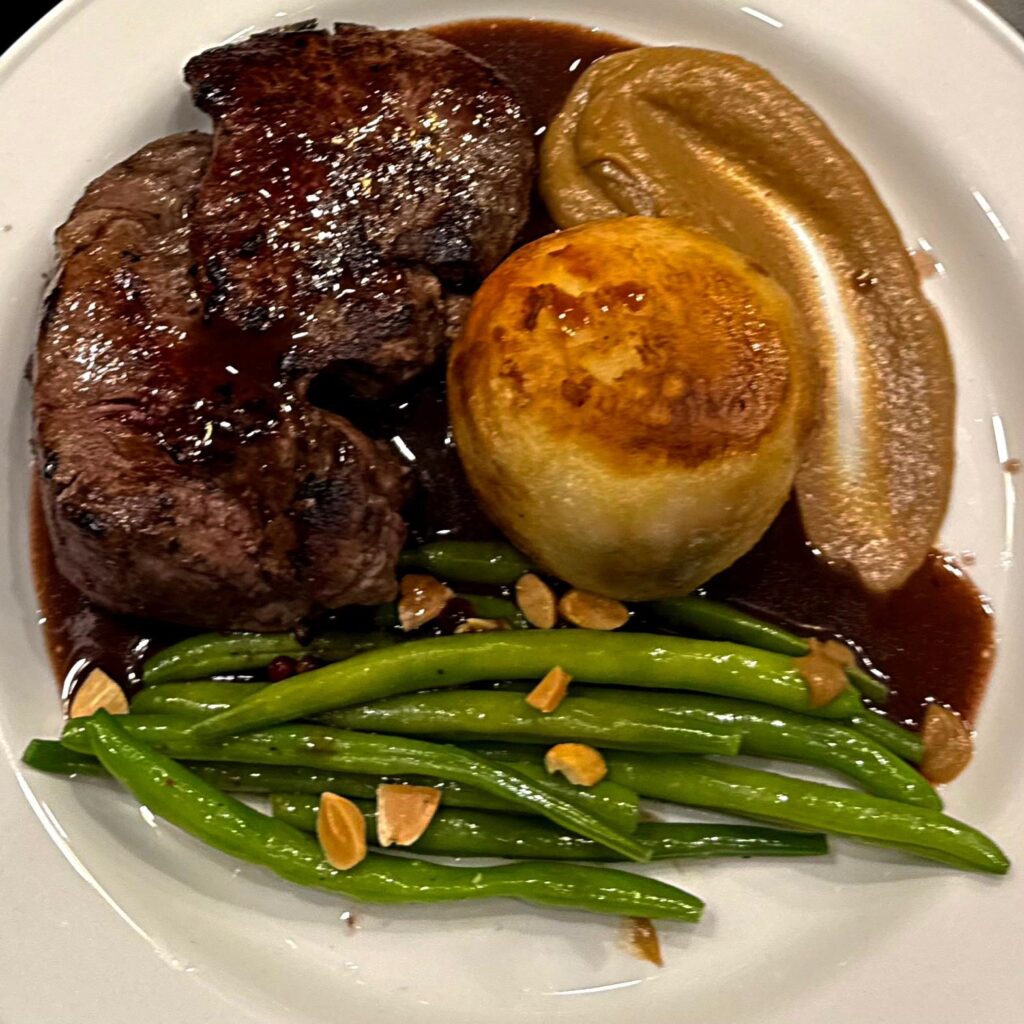 Striploin steak with fondant potato and green beans, plated by Meals with Chef